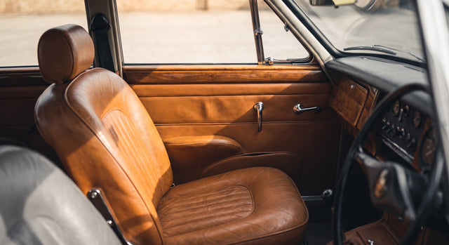 The tan leather interior of a well kept older car