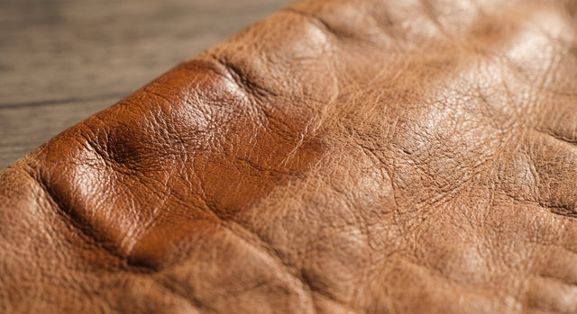 Leather care products beside a well kept leather piece